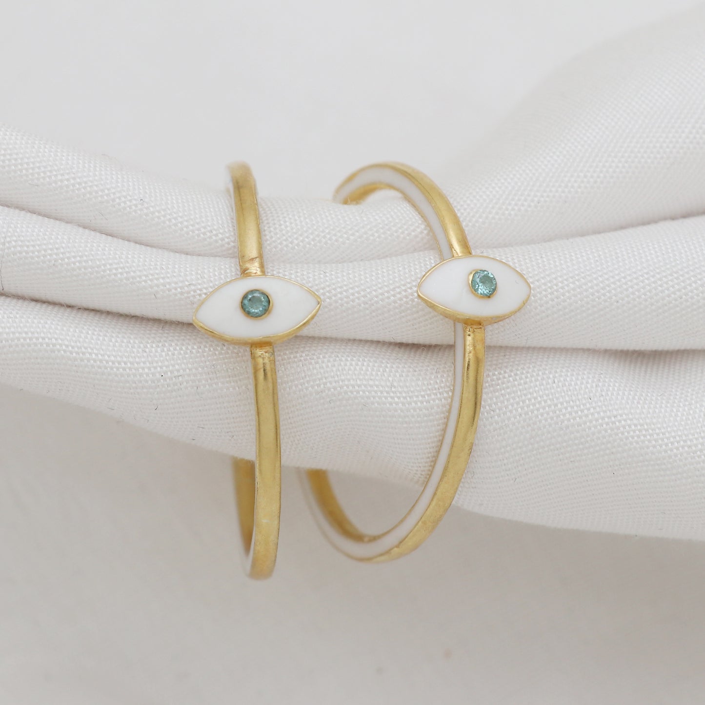 Evil Eye white enamel hoop earrings in gold plated 925 sterling silver with blue topaz gemstone
