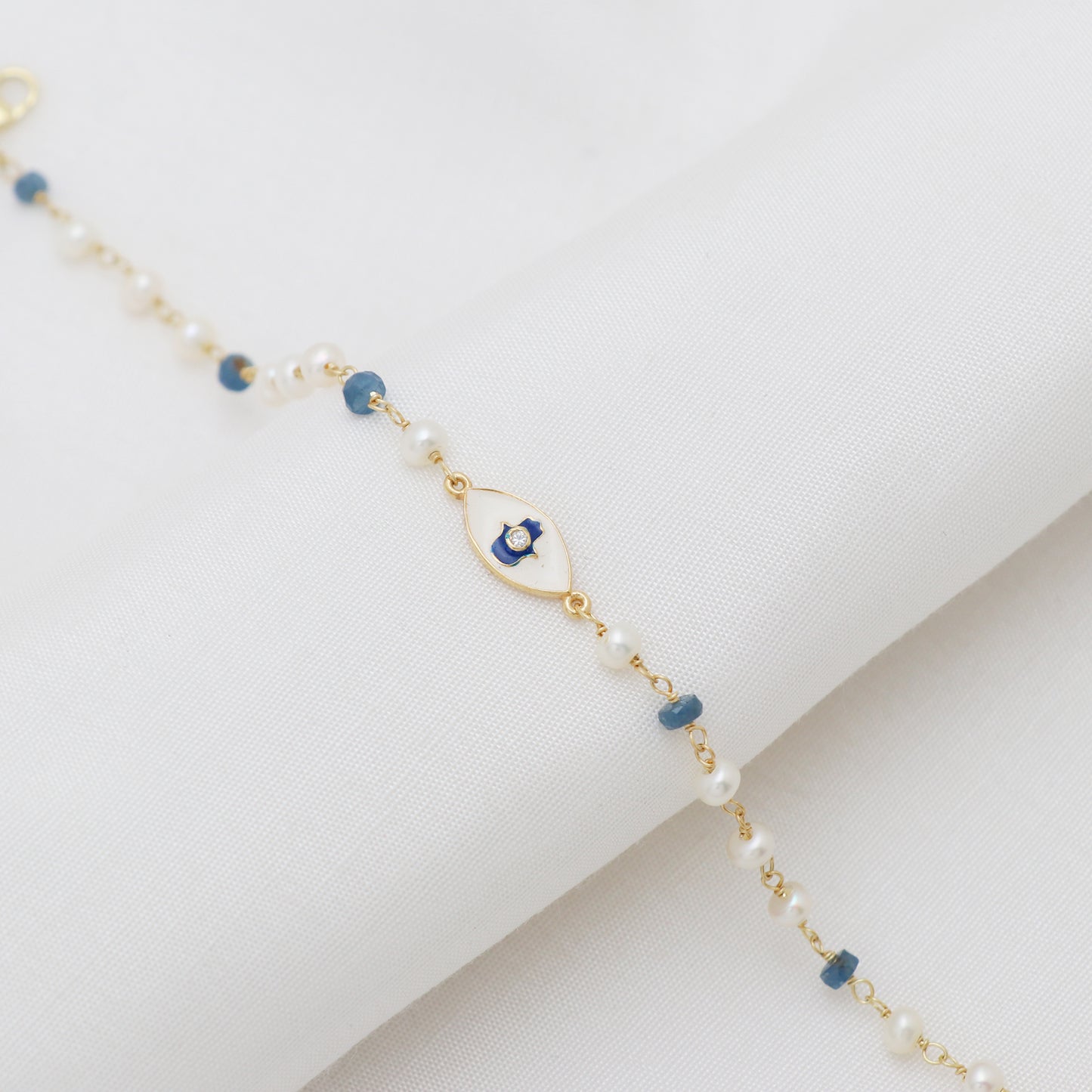 Blue Sapphire and pearl hamsa charm rosary bracelet with blue and white enamel and zircon stone in gold plated 925 sterling silver