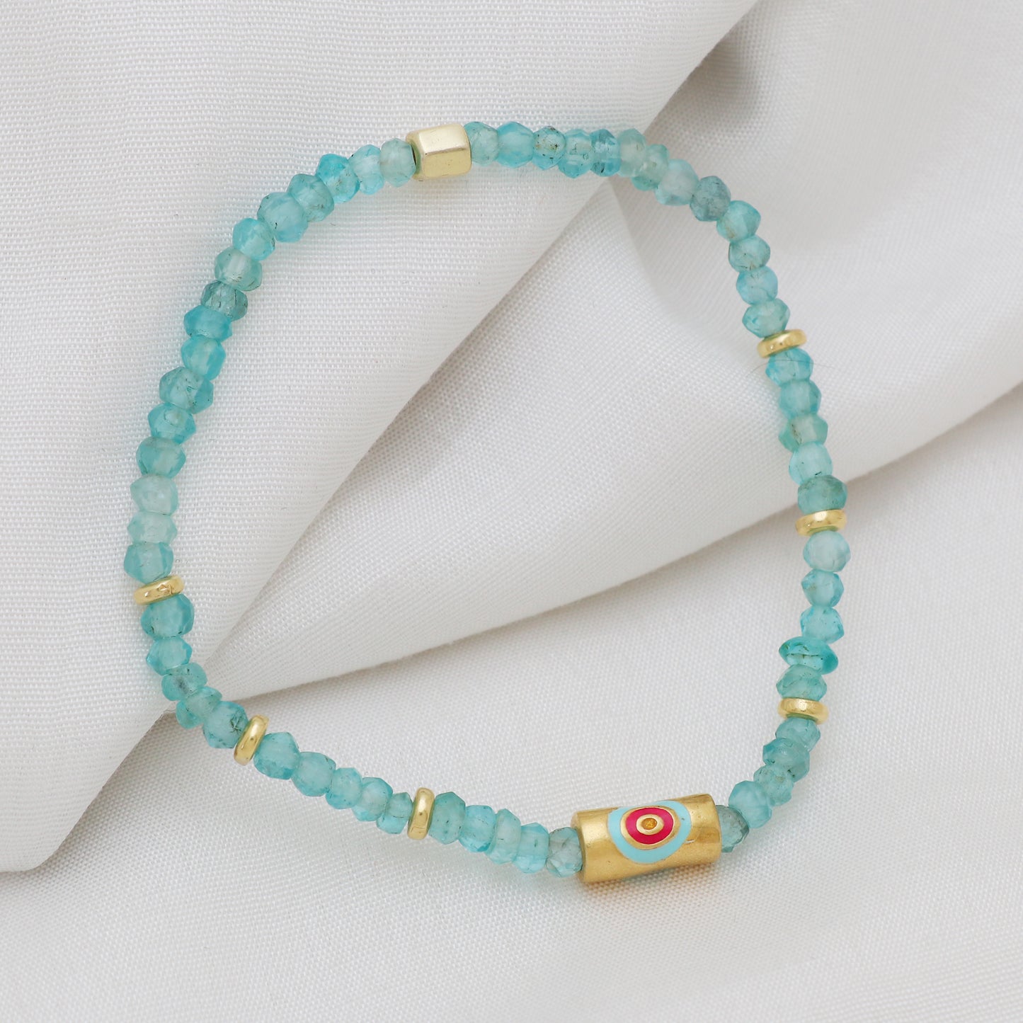 Apatite evil eye charm stretch bracelet with pink and blue enamel in gold plated 925 sterling silver