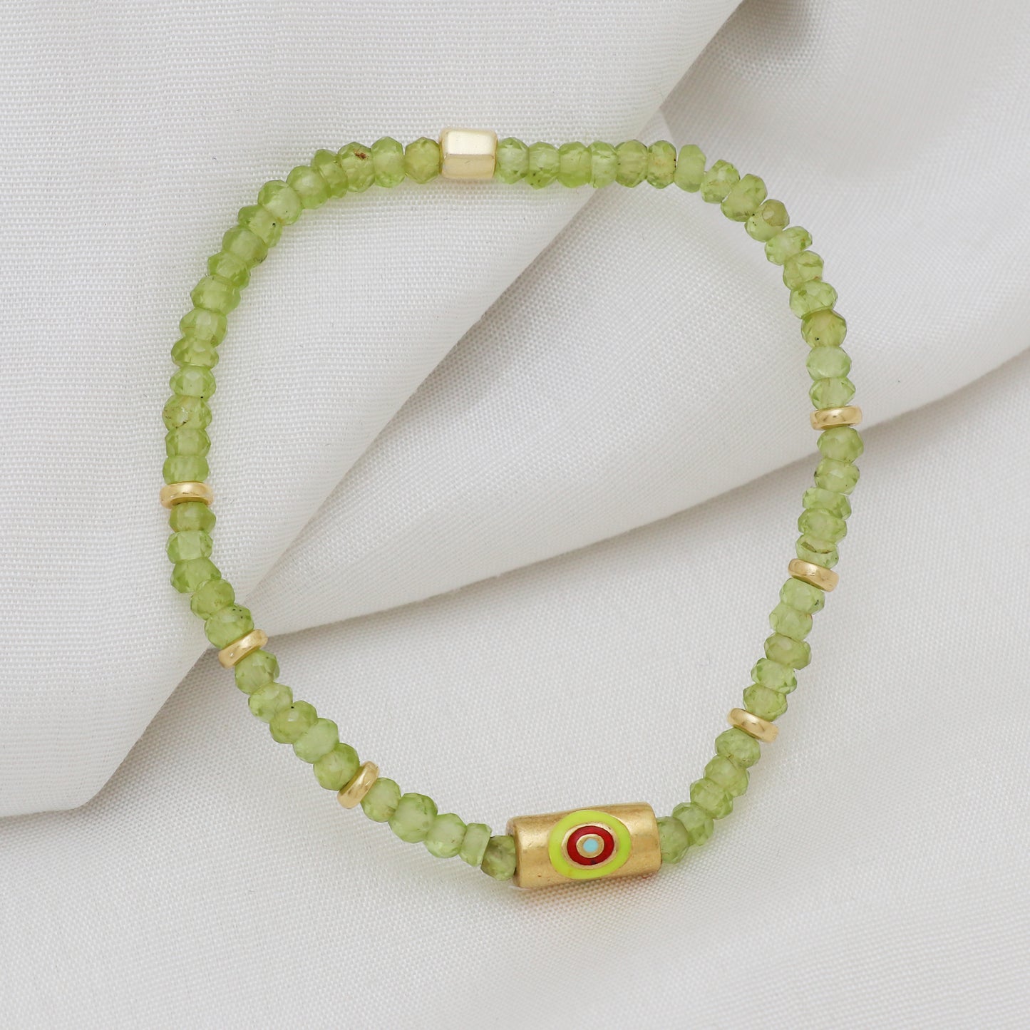 Peridot evil eye charm stretch bracelet with green, red and blue enamel in gold plated 925 sterling silver