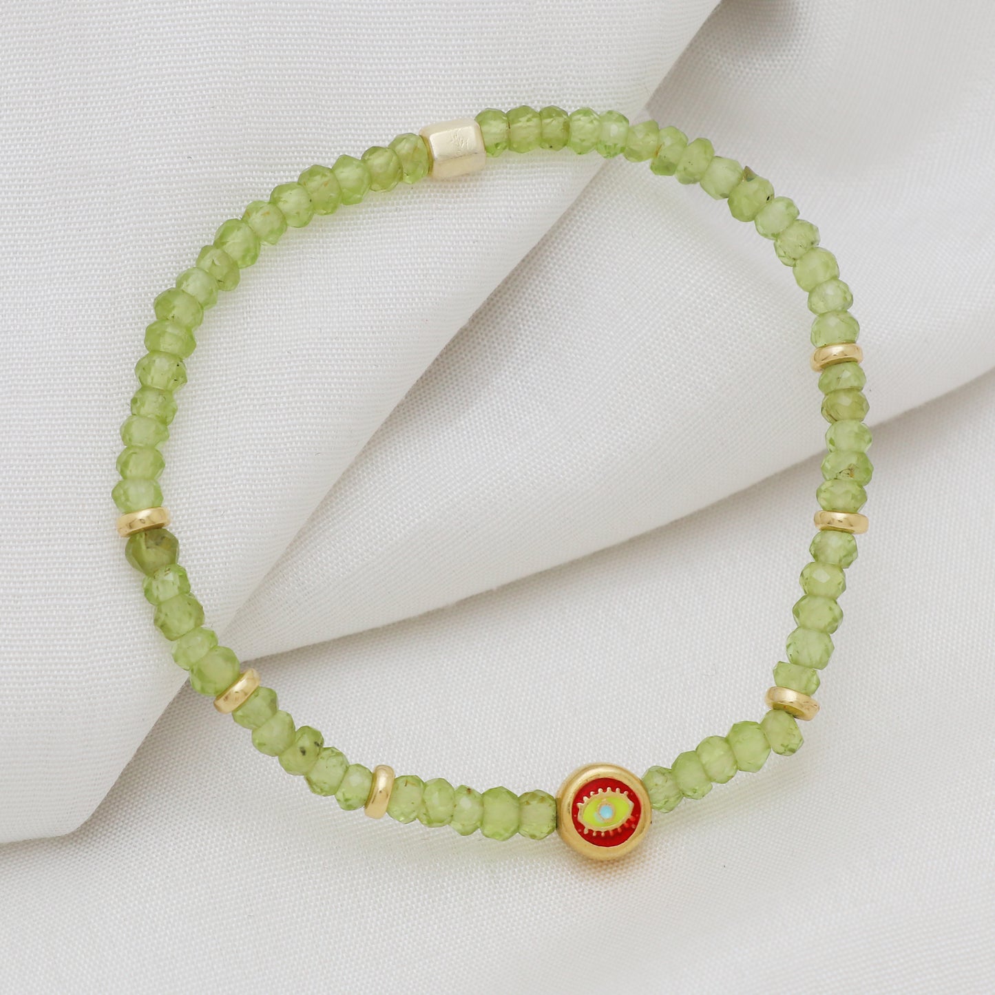 Peridot evil eye charm stretch bracelet with yellow, red and blue enamel in gold plated 925 sterling silver