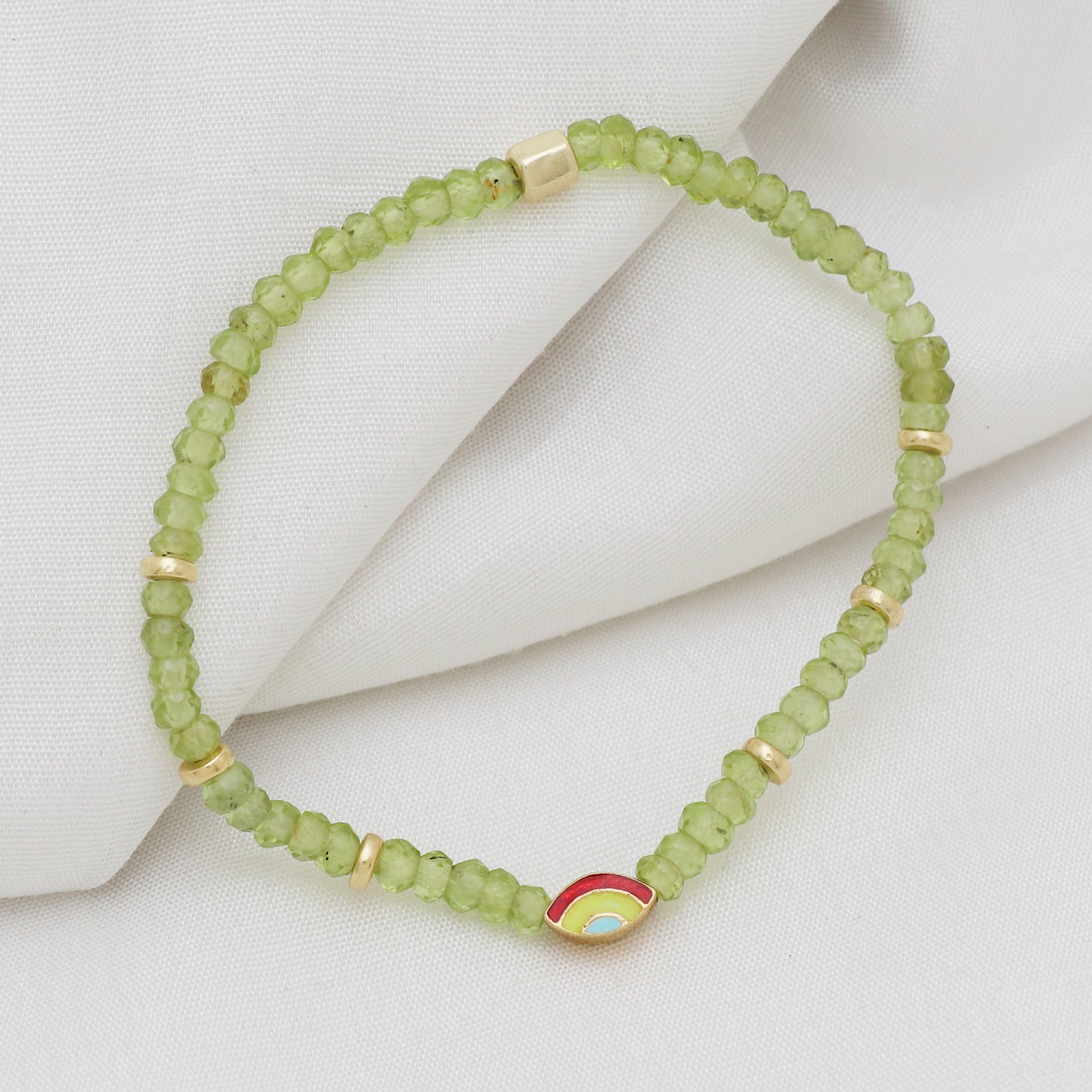 Peridot evil eye charm stretch bracelet with green, red and blue enamel in gold plated 925 sterling silver