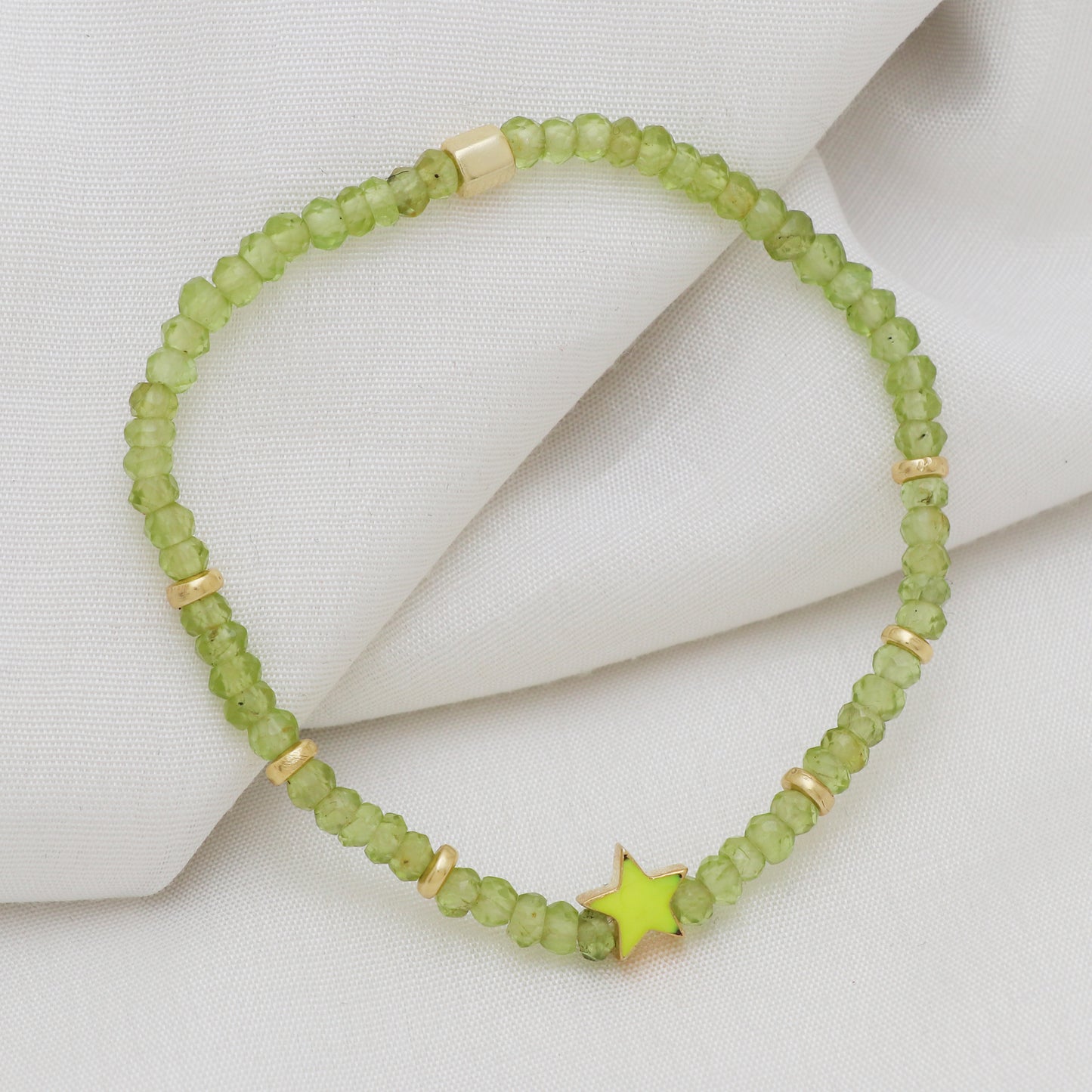 Peridot star charm stretch bracelet with green enamel in gold plated 925 sterling silver.