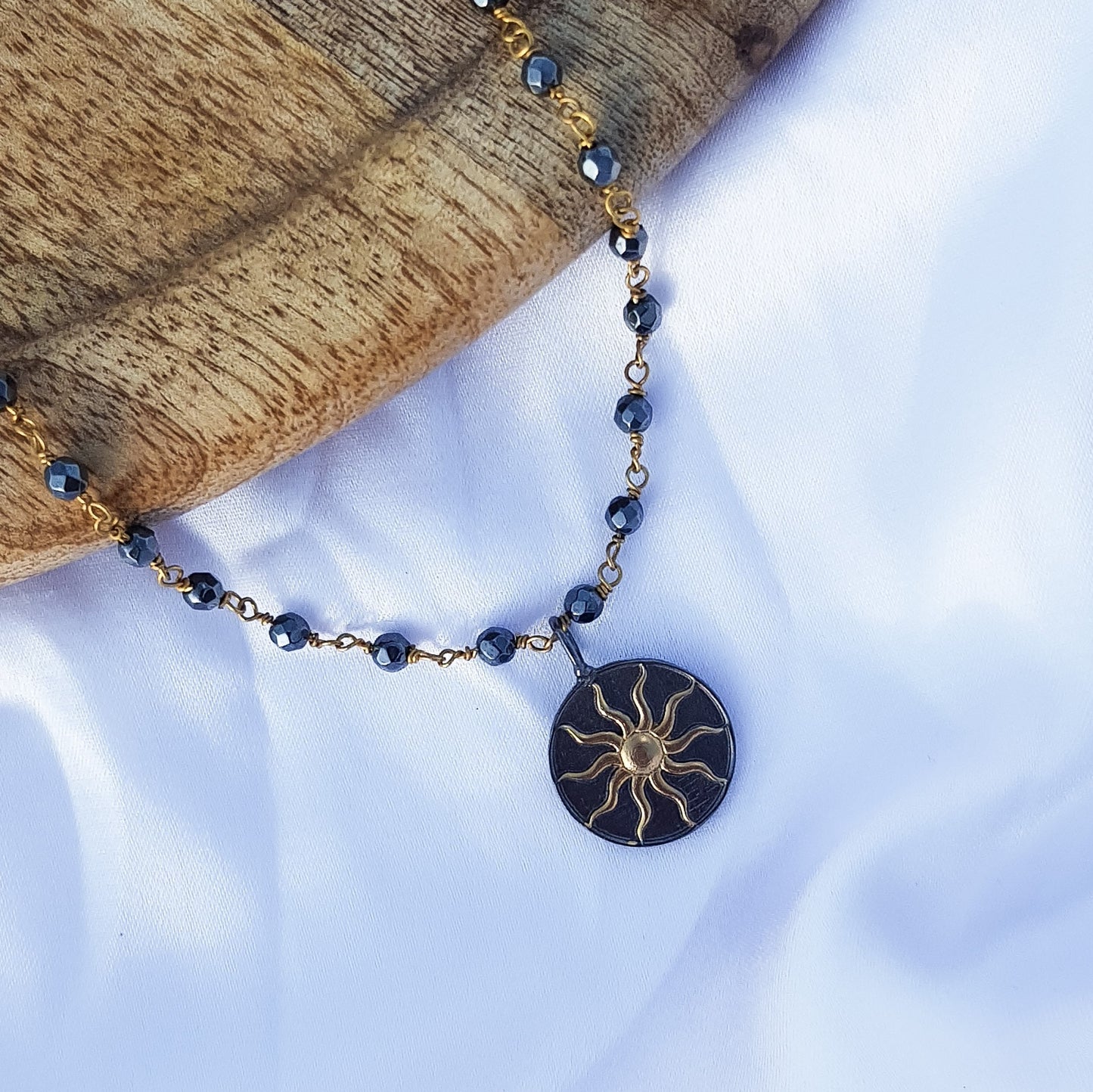 Hematite beaded necklace with Sun charm in two tone black rhodium and 22k gold plated 925 sterling silver