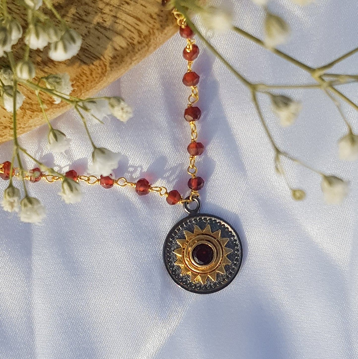 Garnet beaded necklace with Sun charm in two tone black rhodium and 22k gold plated 925 sterling silver