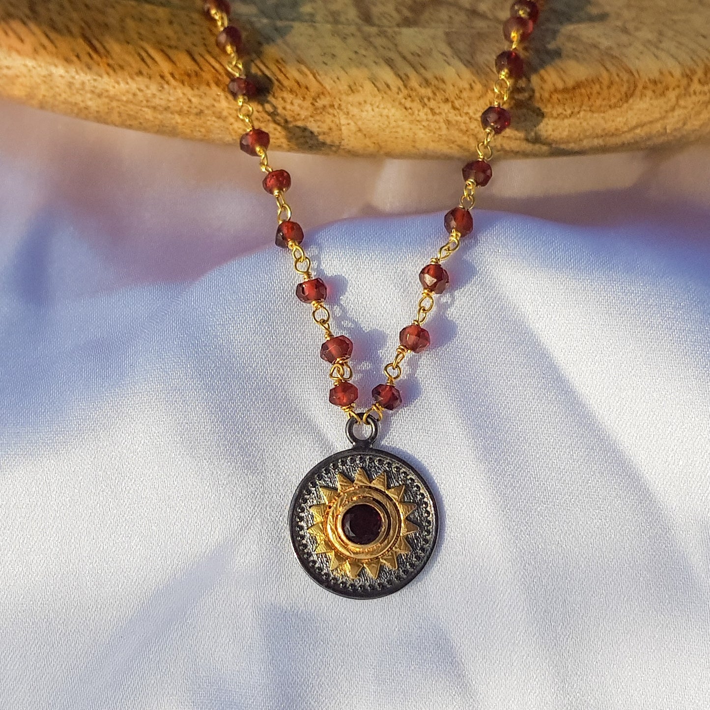 Garnet beaded necklace with Sun charm in two tone black rhodium and 22k gold plated 925 sterling silver