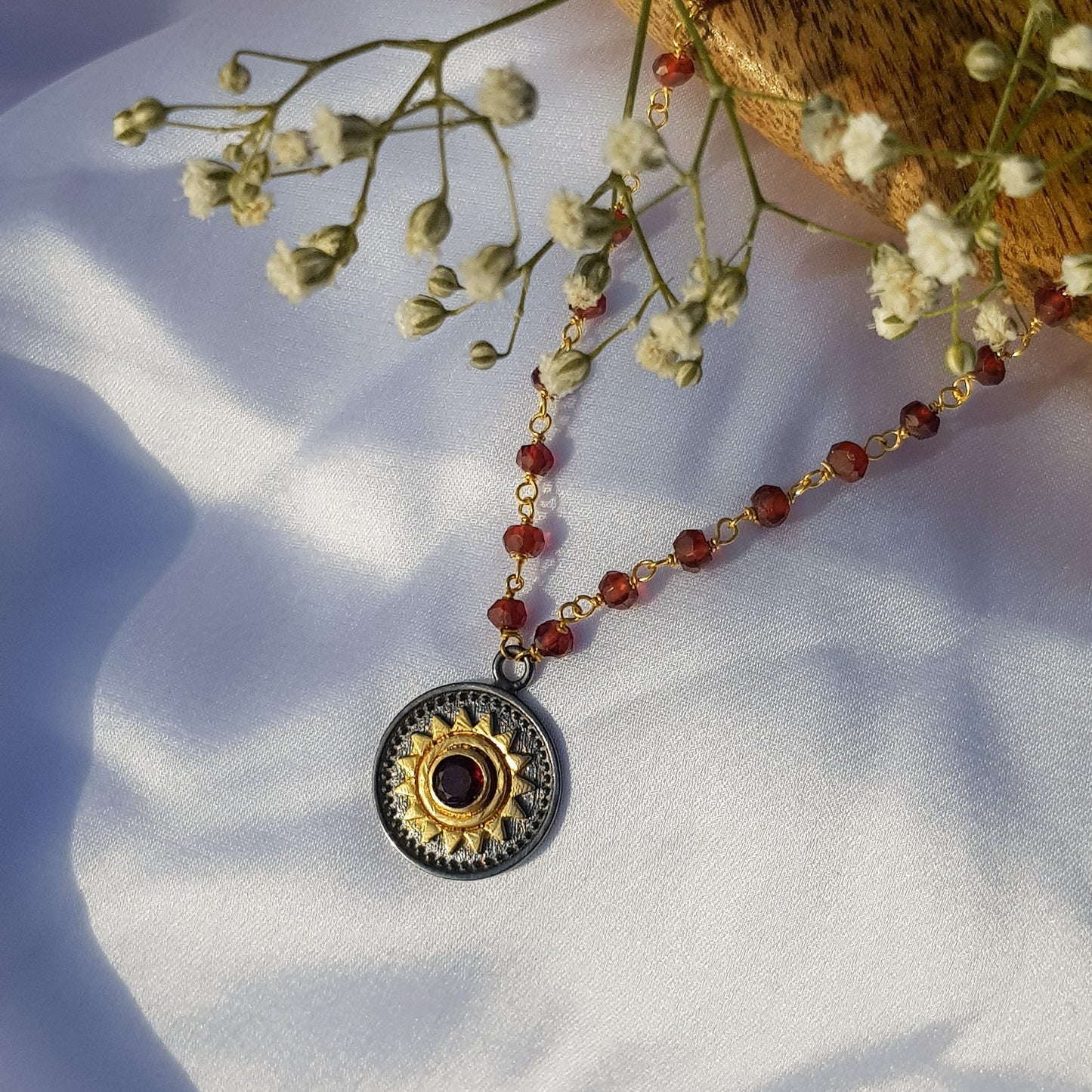 Garnet beaded necklace with Sun charm in two tone black rhodium and 22k gold plated 925 sterling silver