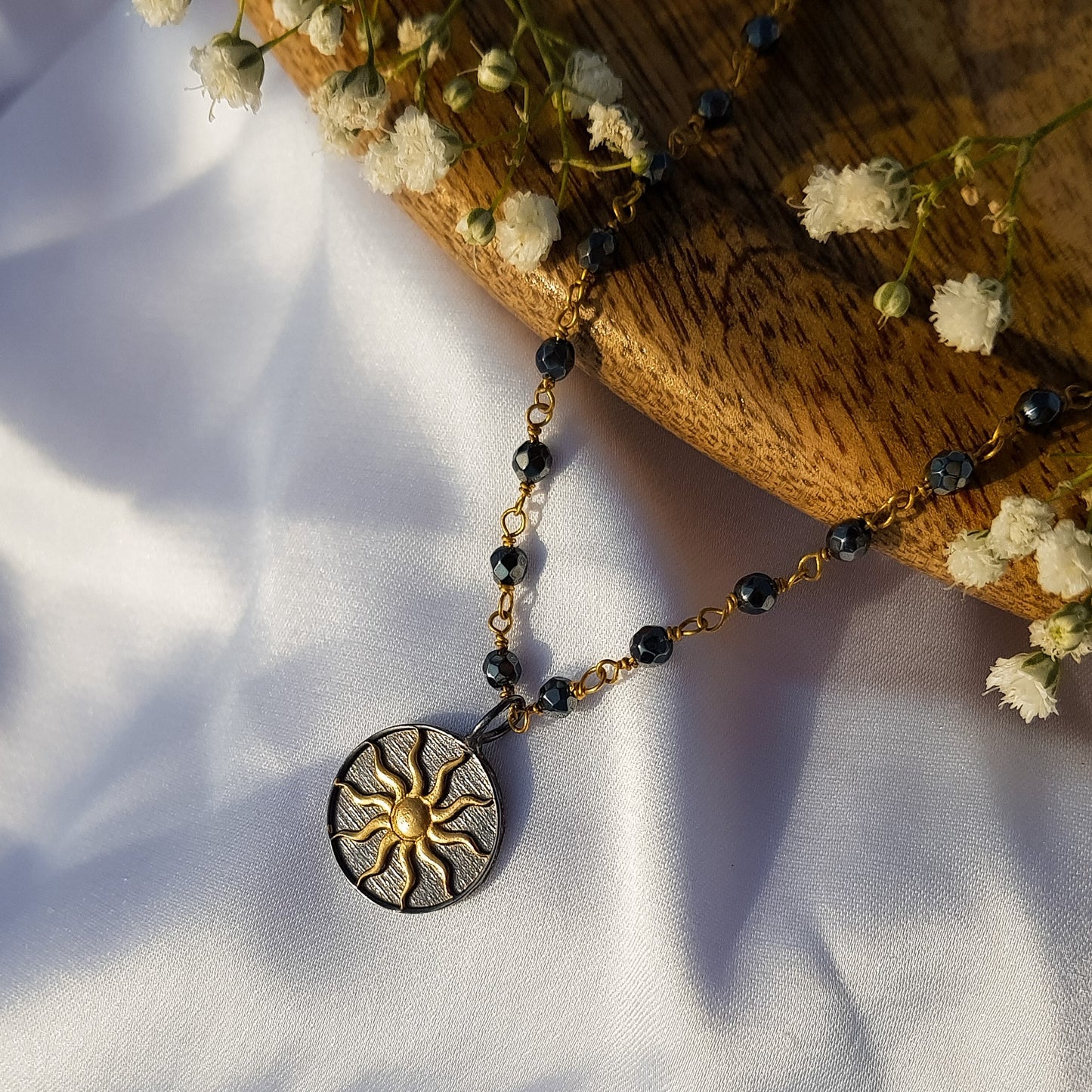 Hematite beaded necklace with Sun charm in two tone black rhodium and 22k gold plated 925 sterling silver