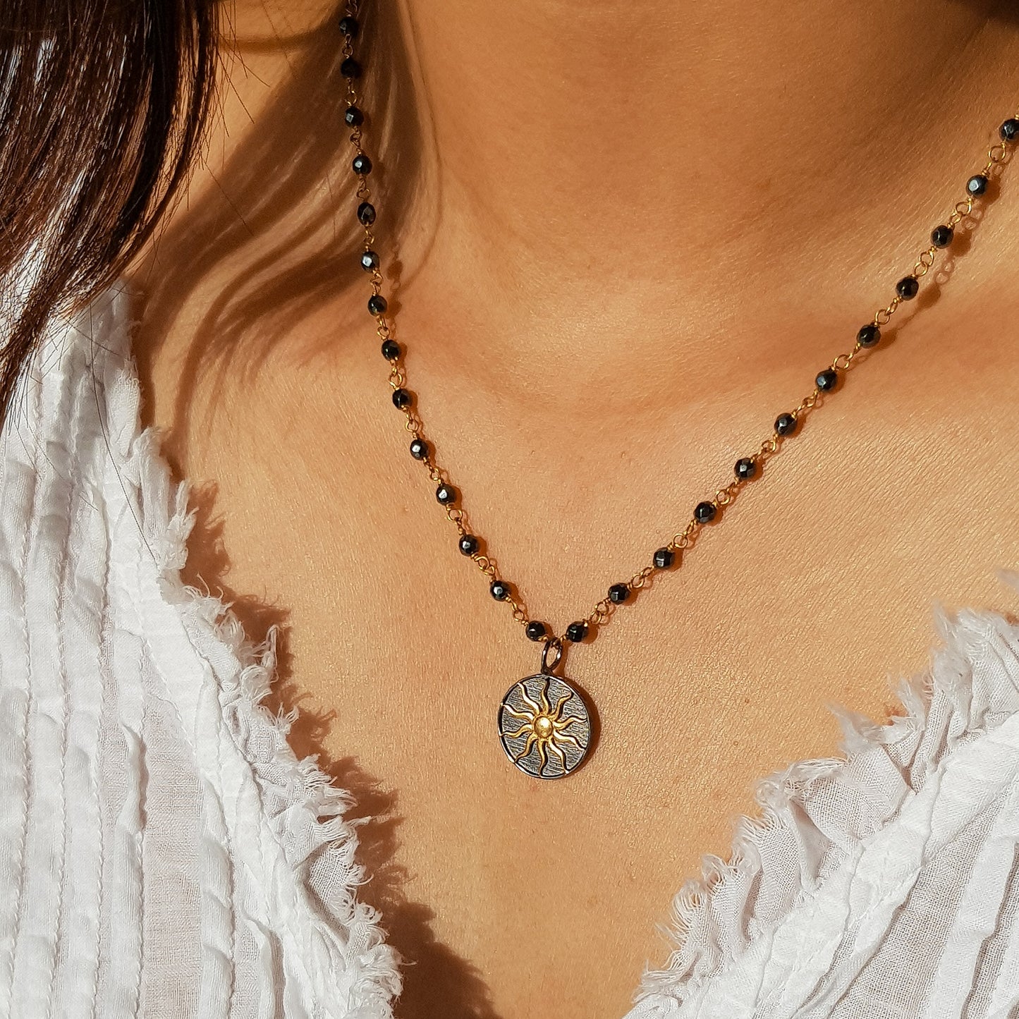 Hematite beaded necklace with Sun charm in two tone black rhodium and 22k gold plated 925 sterling silver