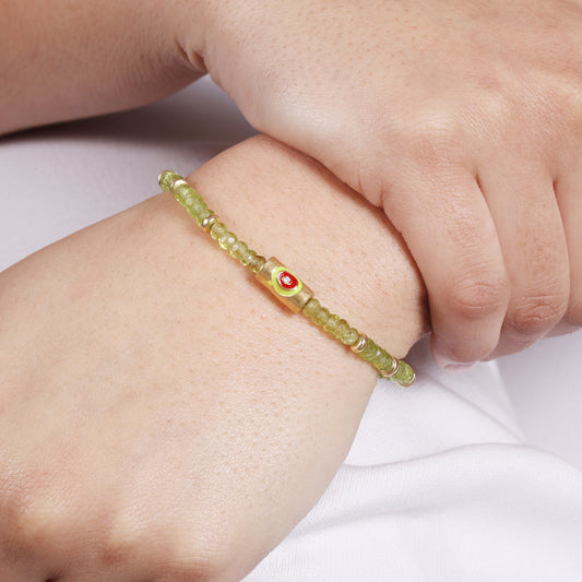 Peridot evil eye charm stretch bracelet with green, red and blue enamel in gold plated 925 sterling silver