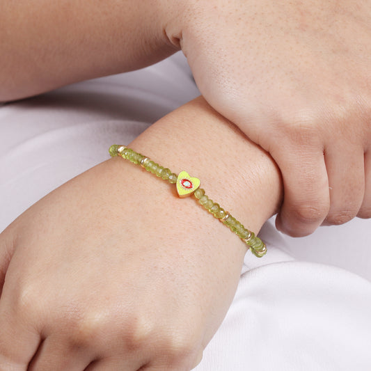 Peridot heart charm with evil eye engraved stretch bracelet with green and red enamel in gold plated 925 sterling silver