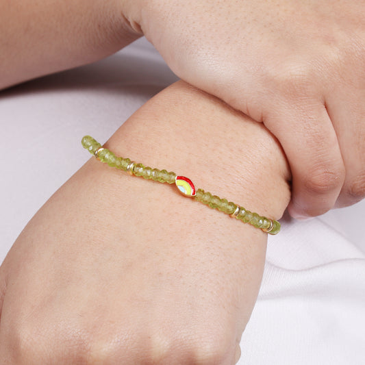 Peridot evil eye charm stretch bracelet with green, red and blue enamel in gold plated 925 sterling silver