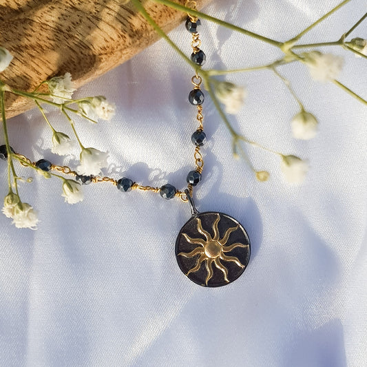 Hematite beaded necklace with Sun charm in two tone black rhodium and 22k gold plated 925 sterling silver