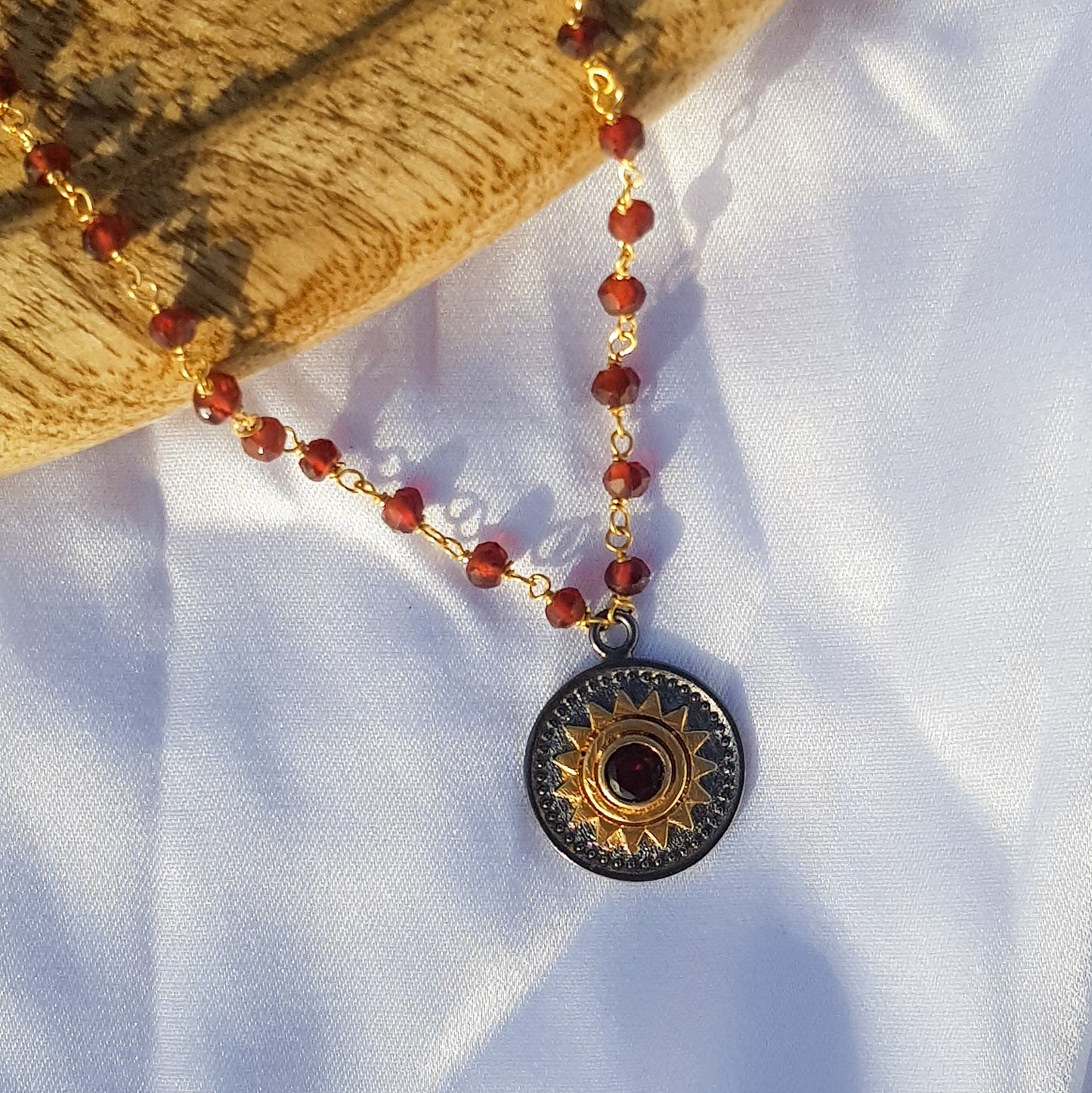 Garnet beaded necklace with Sun charm in two tone black rhodium and 22k gold plated 925 sterling silver