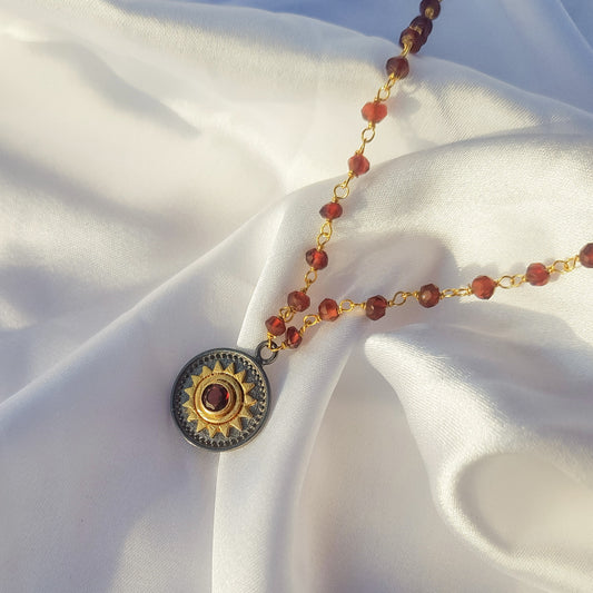 Garnet beaded necklace with Sun charm in two tone black rhodium and 22k gold plated 925 sterling silver