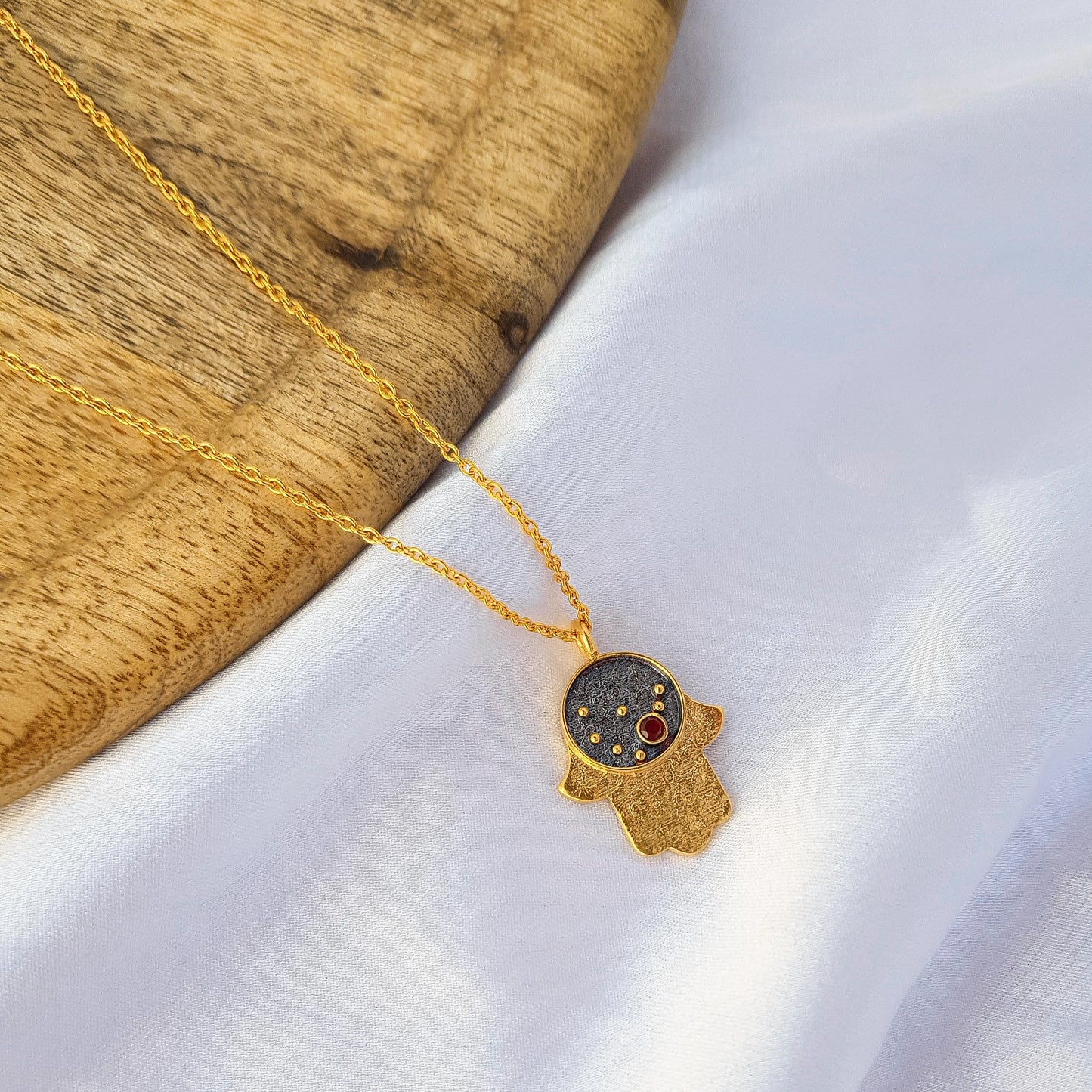 Capricorn Zodiac Constellation chain necklace with Hamsa Charm and Garnet birthstone in two tone black rhodium and 22k gold plated 925 sterling silver