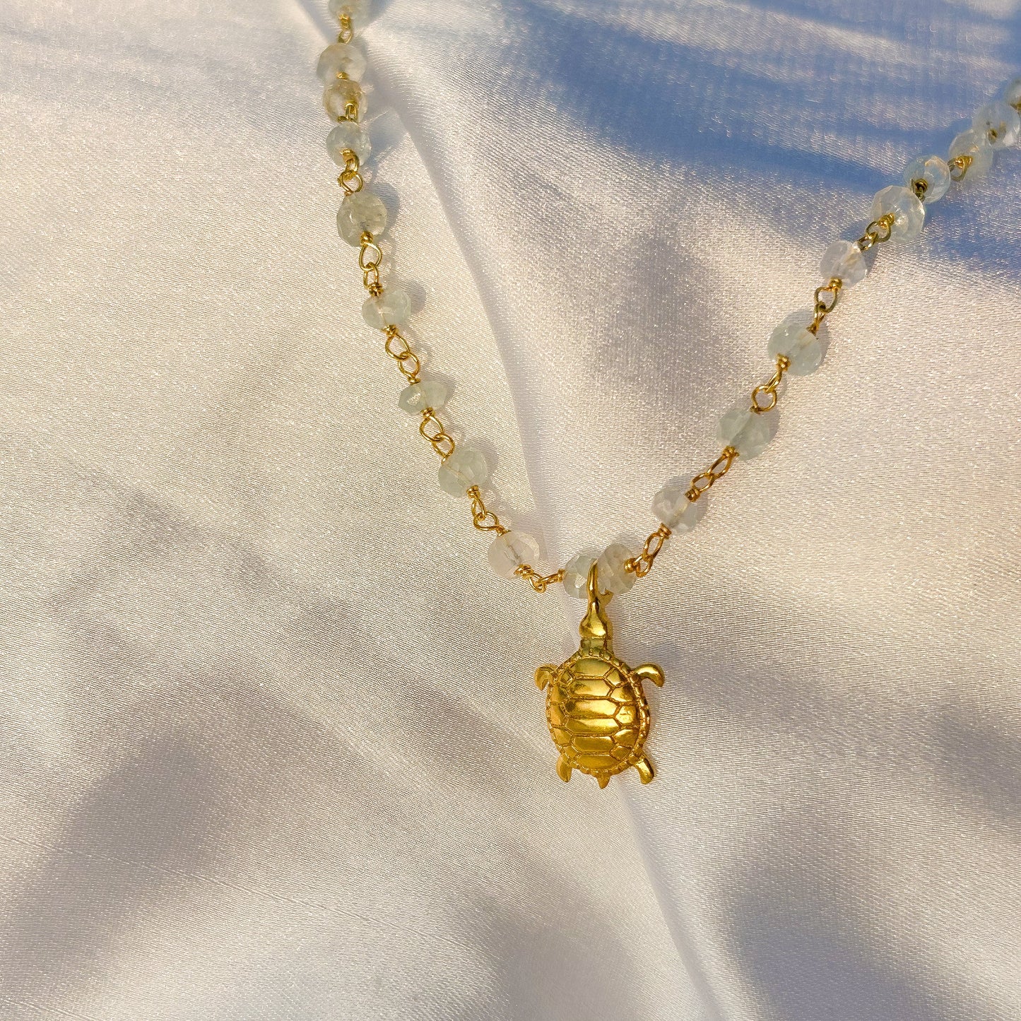 Aquamarine beaded necklace with Turtle charm in gold plated Brass