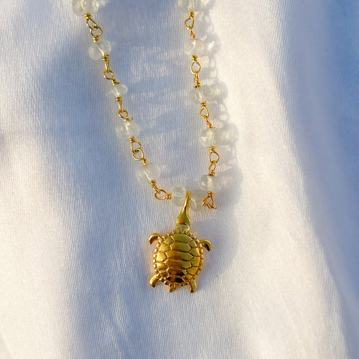 Aquamarine beaded necklace with Turtle charm in gold plated Brass