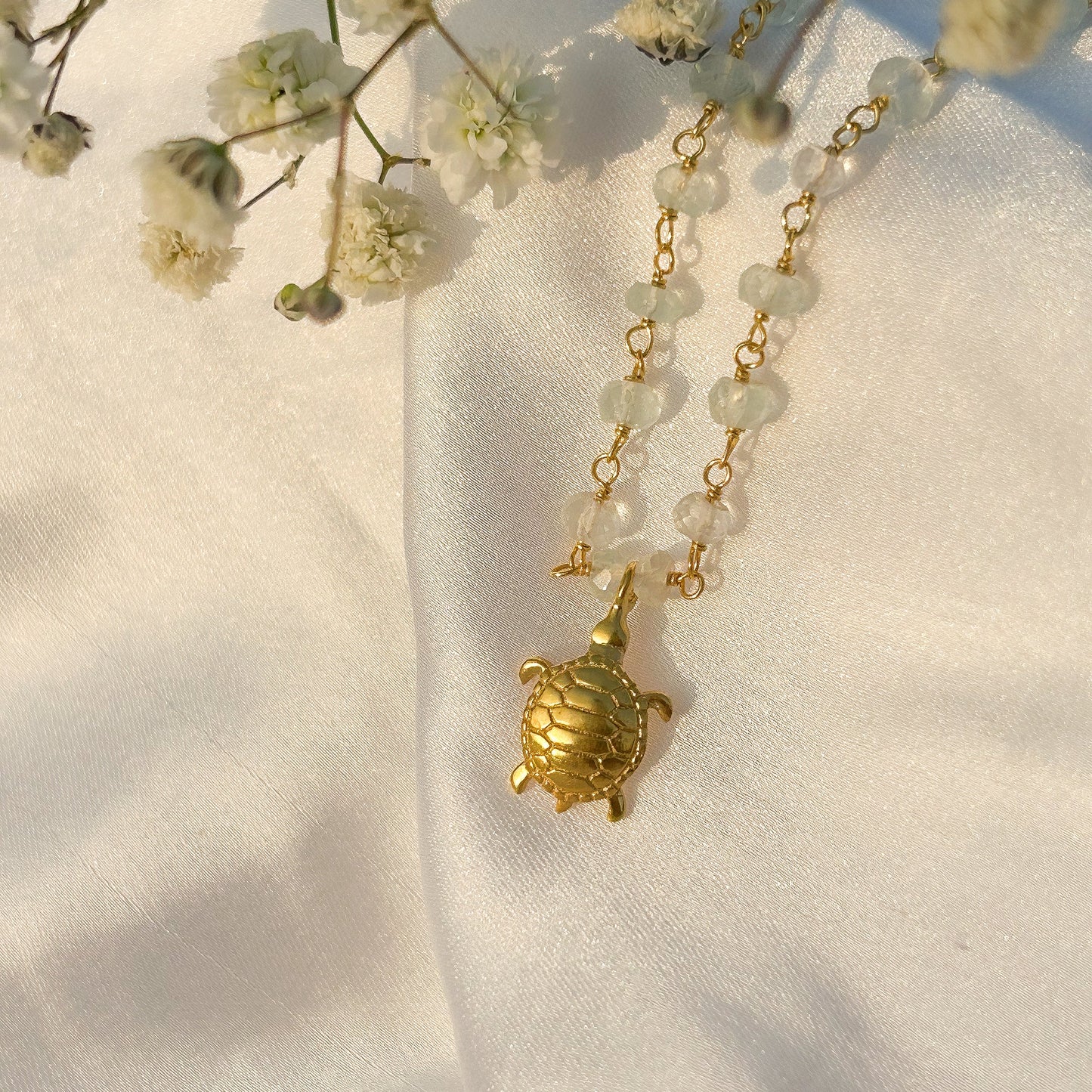Aquamarine beaded necklace with Turtle charm in gold plated Brass