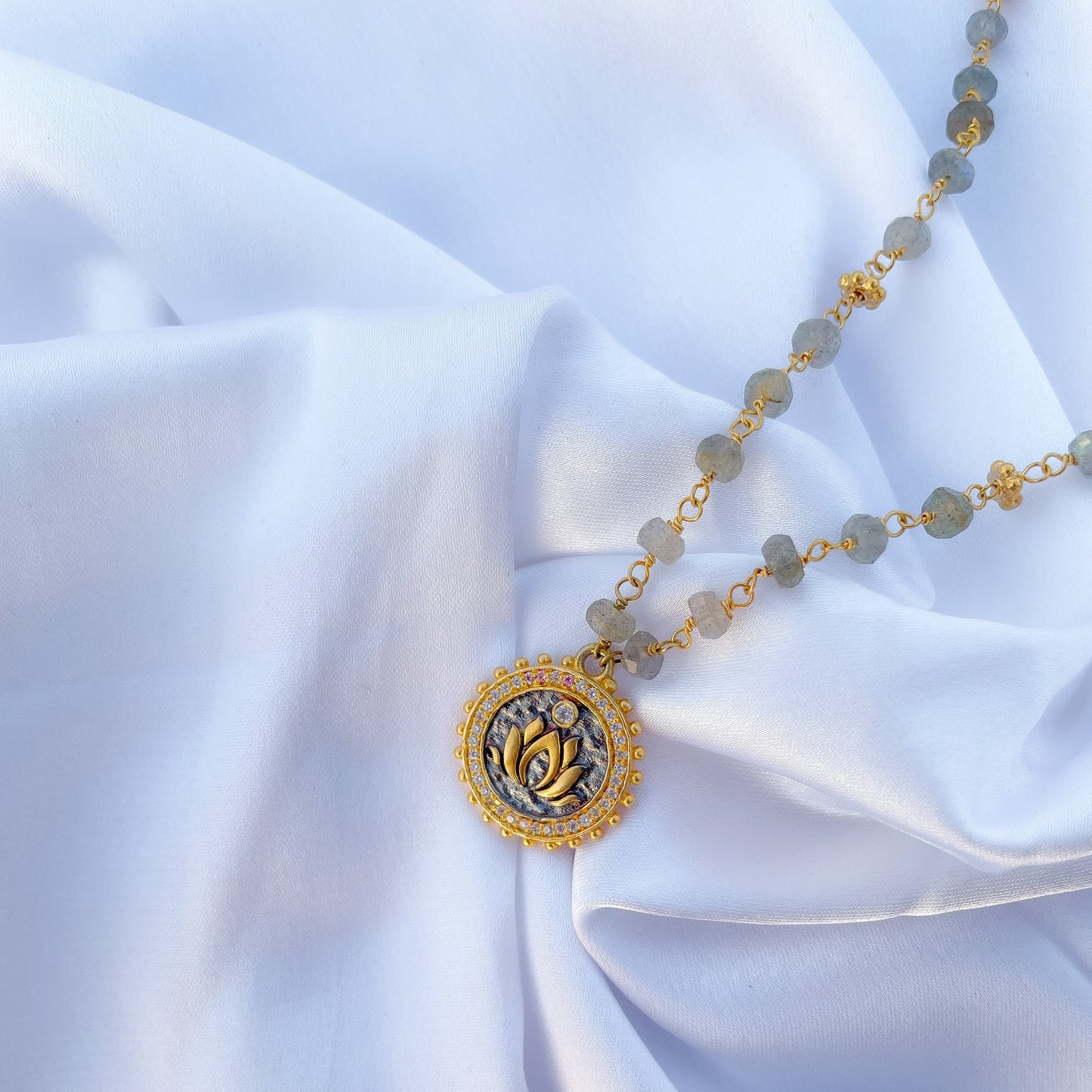 Labradorite beaded necklace with Lotus charm and zircon stones in two tone black rhodium and 22k gold plated 925 sterling silver